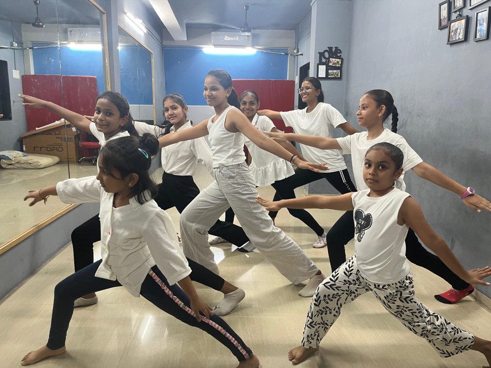 Students practicing dance poses in the studio