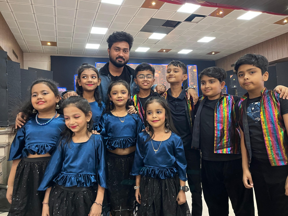 Group photo with young performers in costumes